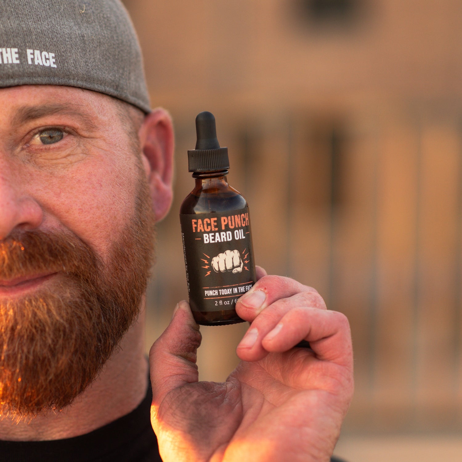 Picture of Dan, The Wheelchair Dad, holding his Face Punch Beard Oil