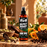 The Rub Secret Sauce Dark Spice body spray in an amber 8 oz spray bottle with woods, citrus and warm spice scent.