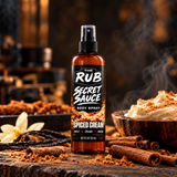The Rub Secret Sauce Spiced Cream body spray in an amber 8 oz spray bottle with a sweet, creamy and warm scent.